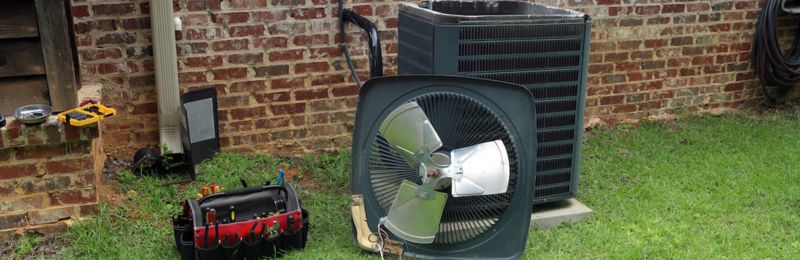 Technician completing a San Diego AC tune up on an outdoor condenser unit
